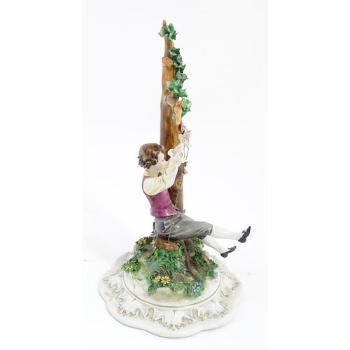 228 - A Capodimonte model of a young boy on a swing. Approx. 10 1/2