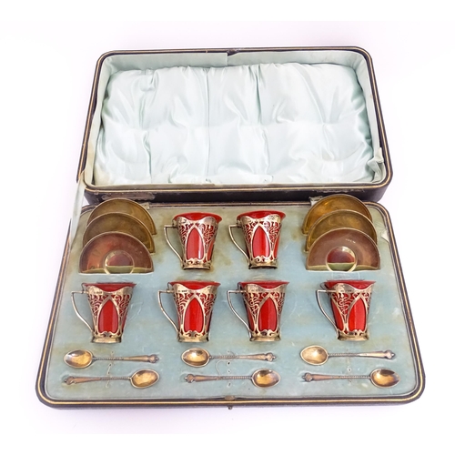 229 - A set of six Royal Doulton flambe coffee cups with Art Nouveau silver mounts, silver saucers and spo... 