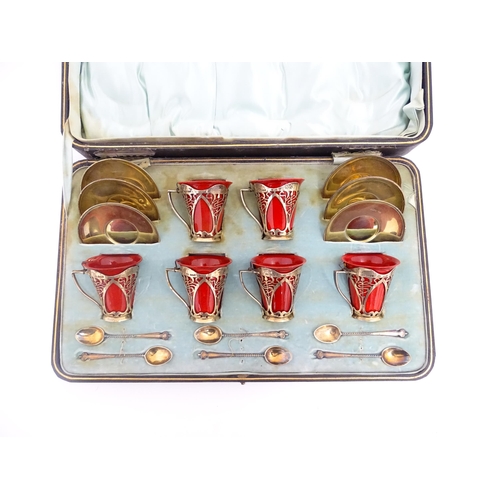 229 - A set of six Royal Doulton flambe coffee cups with Art Nouveau silver mounts, silver saucers and spo... 