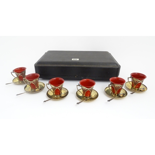 229 - A set of six Royal Doulton flambe coffee cups with Art Nouveau silver mounts, silver saucers and spo... 