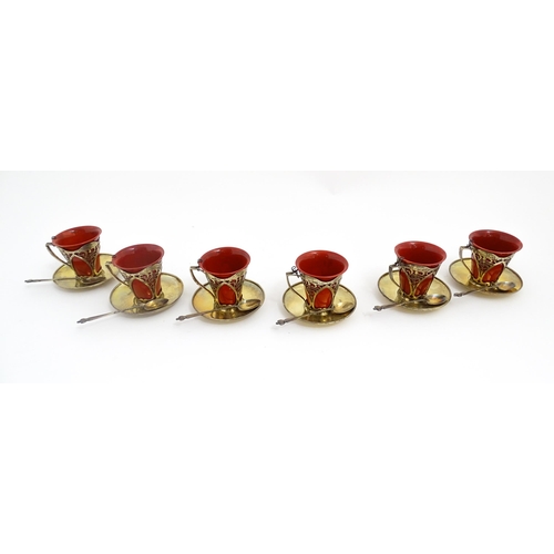 229 - A set of six Royal Doulton flambe coffee cups with Art Nouveau silver mounts, silver saucers and spo... 