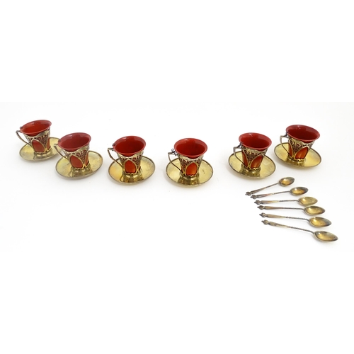 229 - A set of six Royal Doulton flambe coffee cups with Art Nouveau silver mounts, silver saucers and spo... 