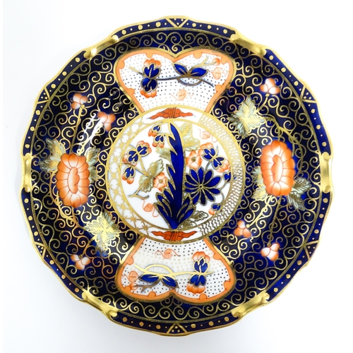 235 - A quantity of Royal Crown Derby tea wares decorated in the Imari palette to include cake plate, cups... 