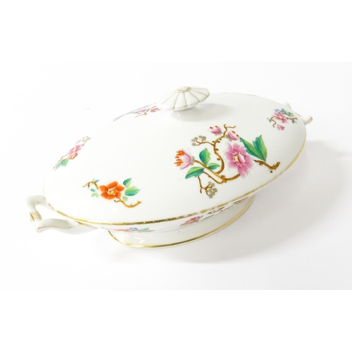 255 - A soup tureen and stand with floral and foliate decoration with gilt highlights. Together with two m... 