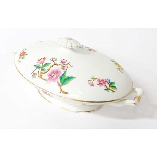 255 - A soup tureen and stand with floral and foliate decoration with gilt highlights. Together with two m... 