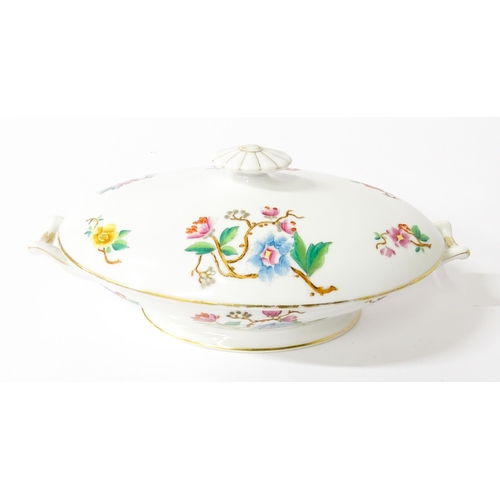 255 - A soup tureen and stand with floral and foliate decoration with gilt highlights. Together with two m... 