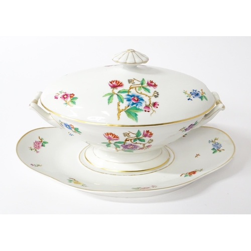 255 - A soup tureen and stand with floral and foliate decoration with gilt highlights. Together with two m... 