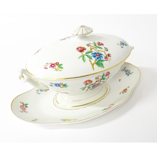 255 - A soup tureen and stand with floral and foliate decoration with gilt highlights. Together with two m... 