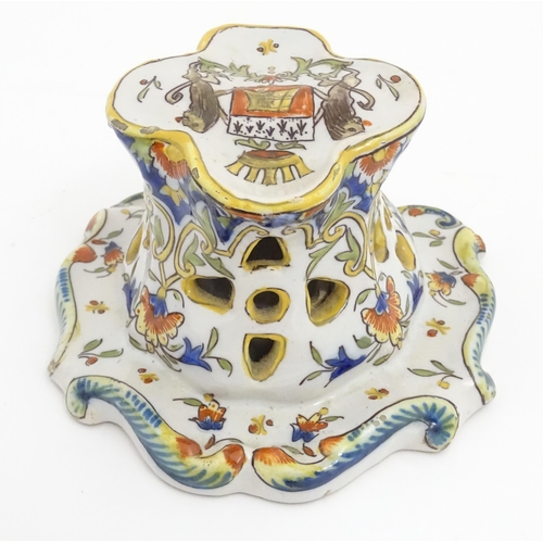 259 - A French faience inkwell of shaped form with armorial to top and scrolling foliate detail. Marked un... 