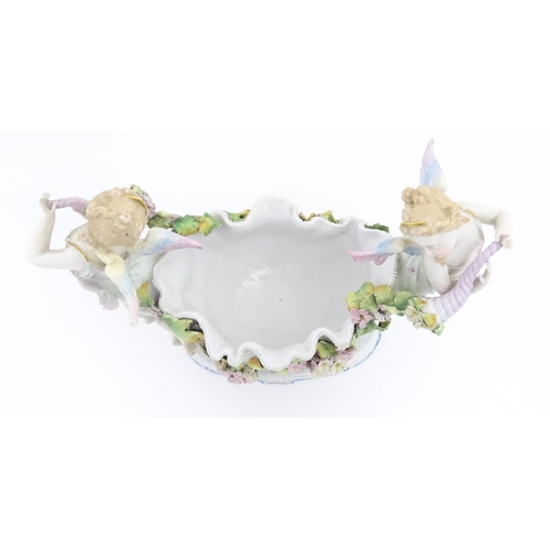 260 - A German porcelain centrepiece dish with cherub / putti and cornucopia detail. Marked under. Approx.... 