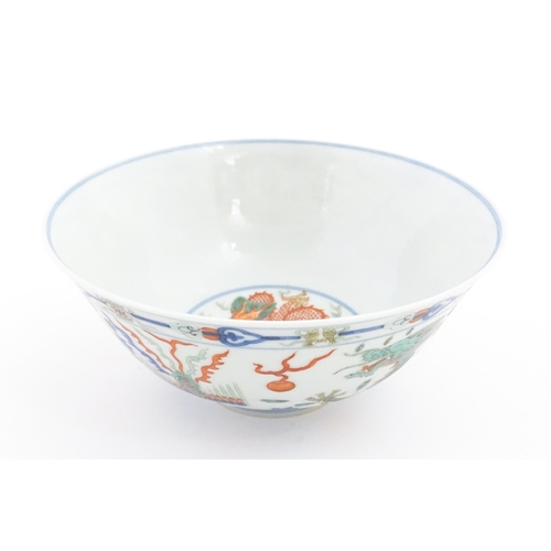 32 - A Chinese bowl decorated with dragons, phoenix birds, flaming pearls and flowers. Character marks un... 