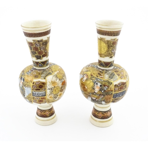 33 - A pair of small Japanese satsuma vases with elongated necks decorated with figures and banded detail... 