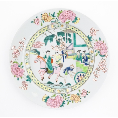 35 - Two Chinese famille rose plates / dishes, one depicting a landscape scene with a figure on horse bac... 