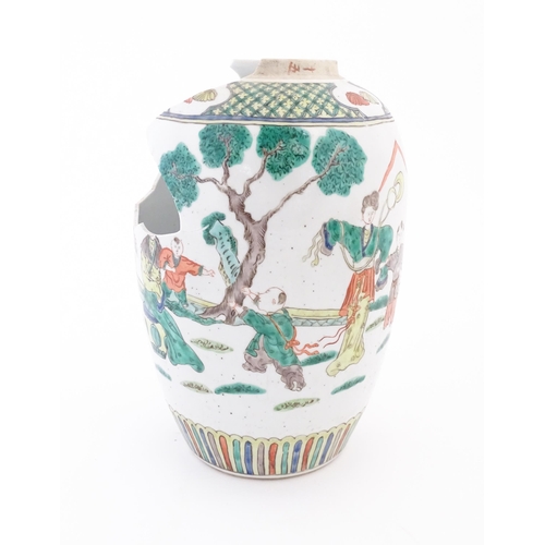 47 - A Chinese famille verte vase decorated with figures in a garden with banded borders. Approx. 11 3/4