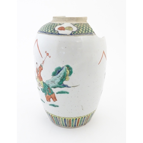 47 - A Chinese famille verte vase decorated with figures in a garden with banded borders. Approx. 11 3/4