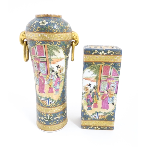 60 - A Chinese vase with twin elephant mask and ring handles decorated with figures with fans on a garden... 