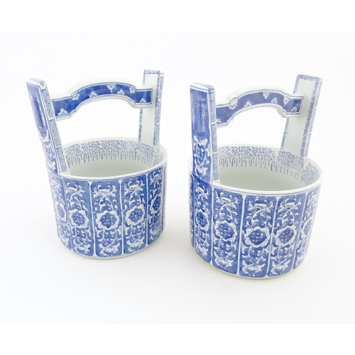62 - A pair of Chinese blue and white planters formed as water pails / buckets with floral and foliate de... 