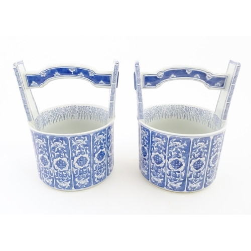 62 - A pair of Chinese blue and white planters formed as water pails / buckets with floral and foliate de... 