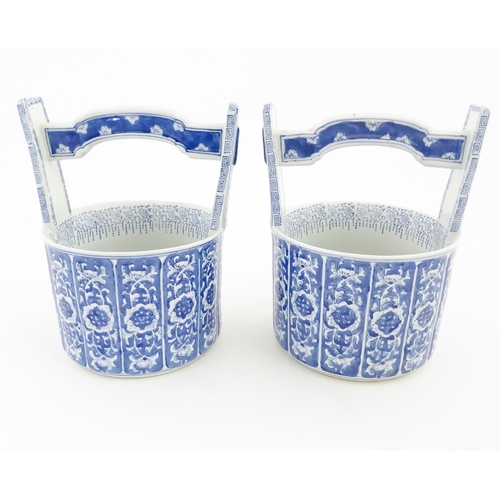 62 - A pair of Chinese blue and white planters formed as water pails / buckets with floral and foliate de... 