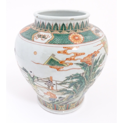 63 - A Chinese famille verte vase / jar decorated with children playing with lanterns etc. on a terrace, ... 