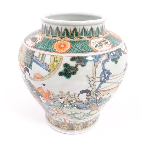 63 - A Chinese famille verte vase / jar decorated with children playing with lanterns etc. on a terrace, ... 