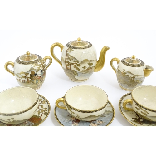 69 - A Japanese Satsuma tea set comprising tea pot, milk jug, twin handled sugar bowl, with six cups and ... 