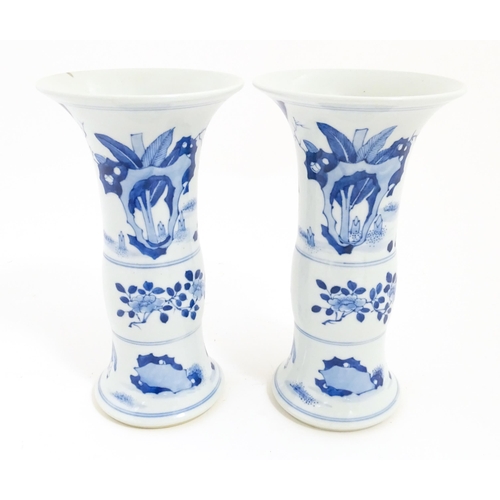 7 - A pair of Chinese blue and white vases with flared rims, decorated with figures on a terrace with ba... 