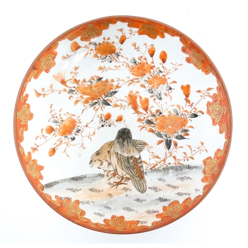 73 - Three Japanese Kutani plates decorated with flowers, foliage and two birds, with foliate detail to r... 