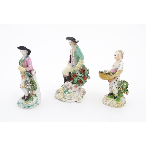 85 - Three ceramic figures comprising a Derby style model of a child holding a basket of flowers, a seate... 