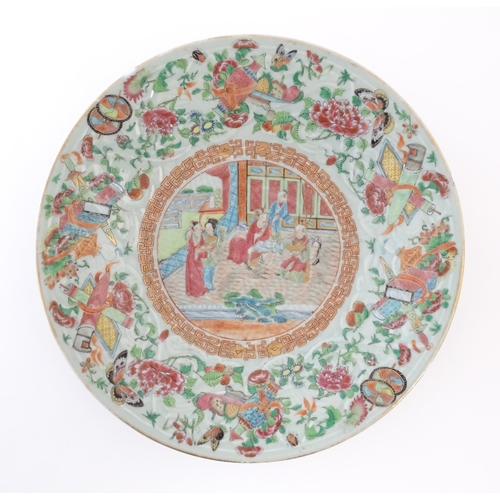 9 - A Chinese / Cantonese famille rose plate decorated with central figural scene bordered by various au... 