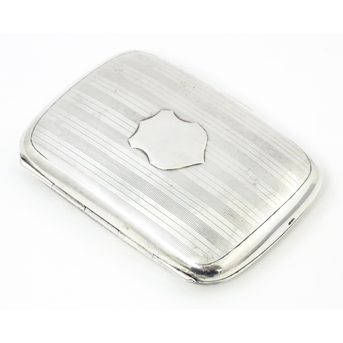 386 - A silver cigarette case with banded engine turned decoration hallmarked Birmingham 1927, maker Henry... 