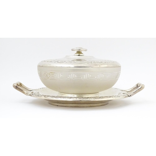 582 - A Victorian butter dish formed from a glass bowl with Greek Key decoration with a twin handled silve... 