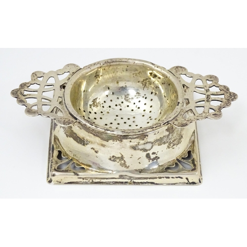 587 - A silver strainer and stand with pierced decoration hallmarked Birmingham 1944, maker Thomas Bishton... 