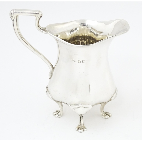 601 - An Art Nouveau silver cream jug hallmarked Birmingham 1908, maker E. S Barnsley & Co. Approx. 4 1/4