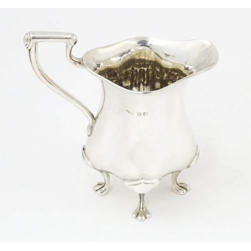 601 - An Art Nouveau silver cream jug hallmarked Birmingham 1908, maker E. S Barnsley & Co. Approx. 4 1/4