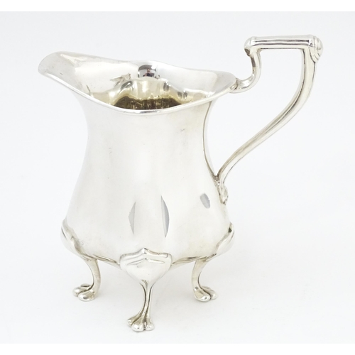 601 - An Art Nouveau silver cream jug hallmarked Birmingham 1908, maker E. S Barnsley & Co. Approx. 4 1/4