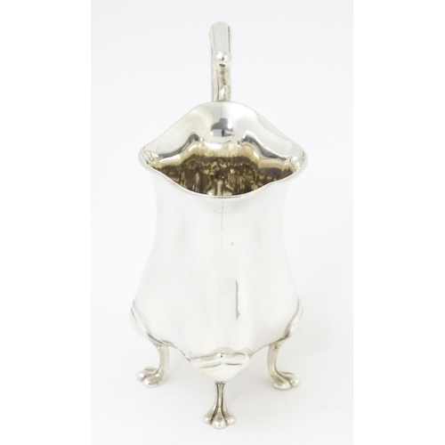 601 - An Art Nouveau silver cream jug hallmarked Birmingham 1908, maker E. S Barnsley & Co. Approx. 4 1/4