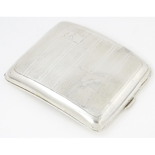 635 - An Art Deco silver cigarette case of shaped form with banded engine turned decoration, Birmingham 19... 