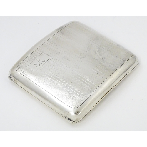 635 - An Art Deco silver cigarette case of shaped form with banded engine turned decoration, Birmingham 19... 