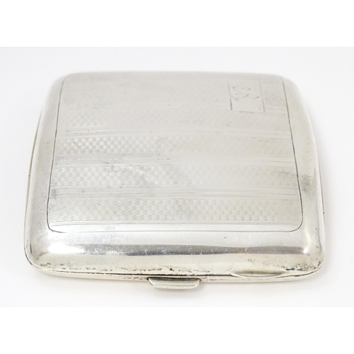 635 - An Art Deco silver cigarette case of shaped form with banded engine turned decoration, Birmingham 19... 