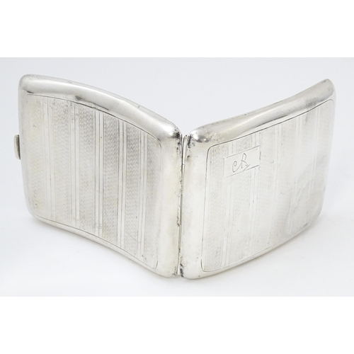 635 - An Art Deco silver cigarette case of shaped form with banded engine turned decoration, Birmingham 19... 