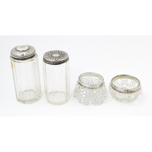 638 - Two cut glass dressing table jars with silver tops hallmarked Birmingham 1901, maker W. H., the othe... 