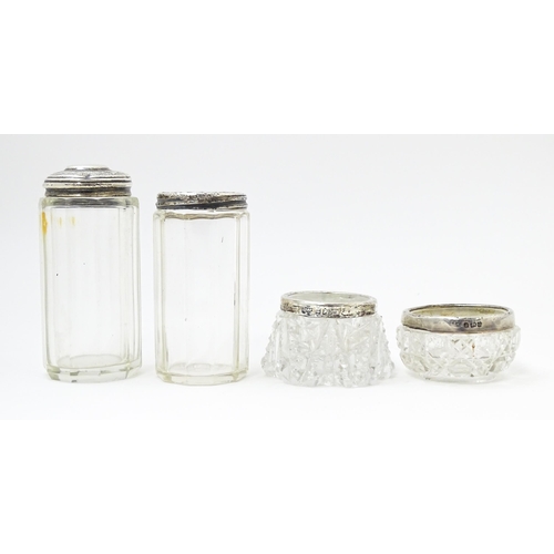 638 - Two cut glass dressing table jars with silver tops hallmarked Birmingham 1901, maker W. H., the othe... 