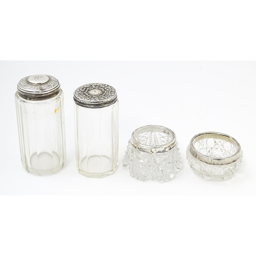 638 - Two cut glass dressing table jars with silver tops hallmarked Birmingham 1901, maker W. H., the othe... 