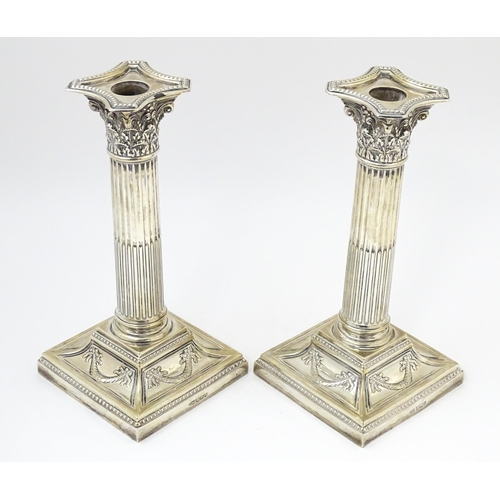 650 - A pair of silver candlesticks of Corinthian column form hallmarked Sheffield 1902, maker Harrison Br... 