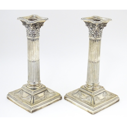 650 - A pair of silver candlesticks of Corinthian column form hallmarked Sheffield 1902, maker Harrison Br... 