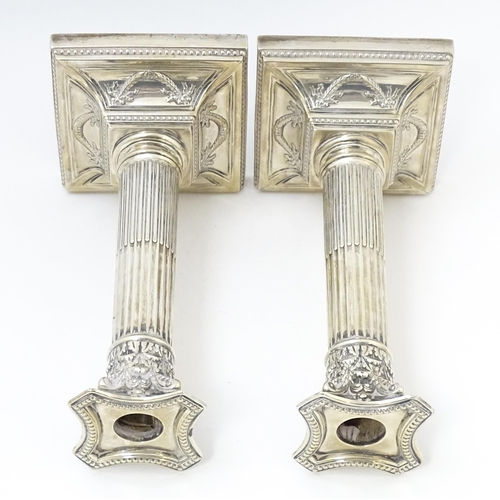 650 - A pair of silver candlesticks of Corinthian column form hallmarked Sheffield 1902, maker Harrison Br... 