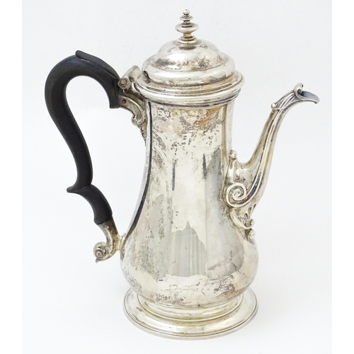 653 - A Geo II silver coffee pot hallmarked London c. 
1752, maker Thomas Whipham. Approx. 8 1/2