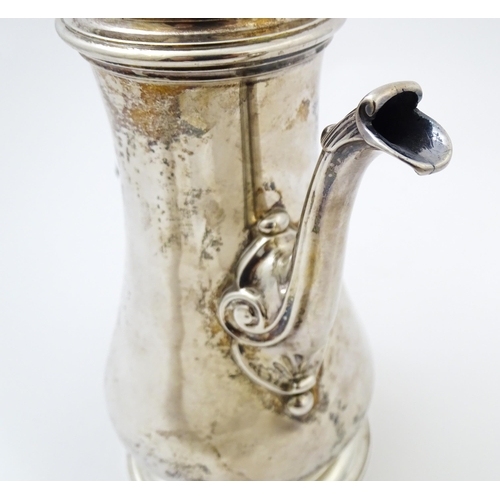 653 - A Geo II silver coffee pot hallmarked London c. 
1752, maker Thomas Whipham. Approx. 8 1/2