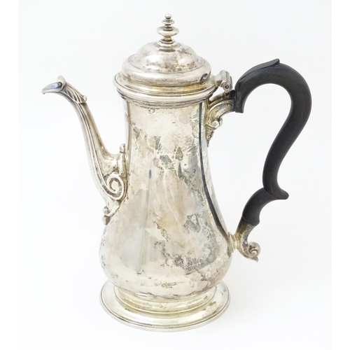 653 - A Geo II silver coffee pot hallmarked London c. 
1752, maker Thomas Whipham. Approx. 8 1/2